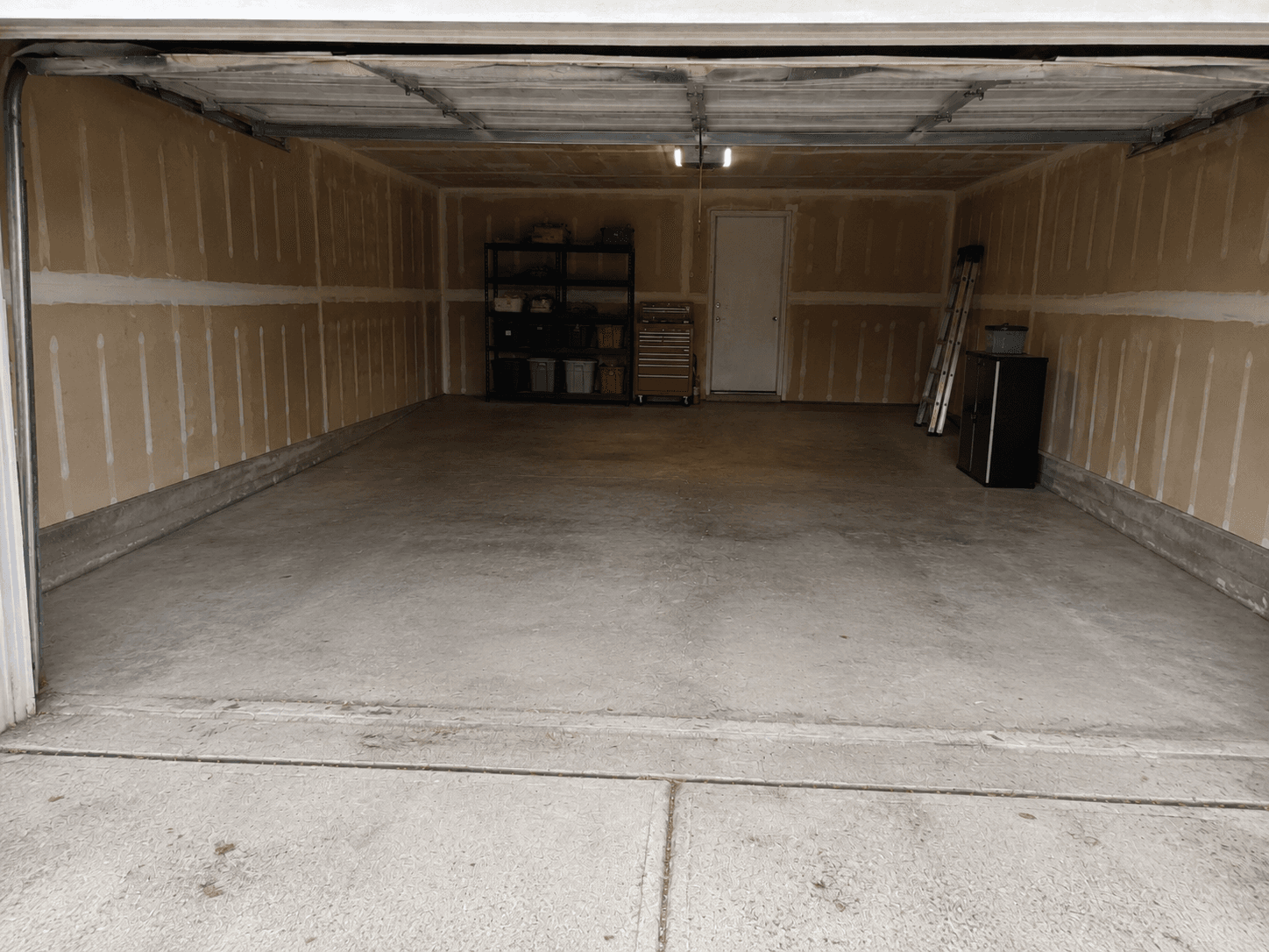 Clean garage with open floor space after junk removal